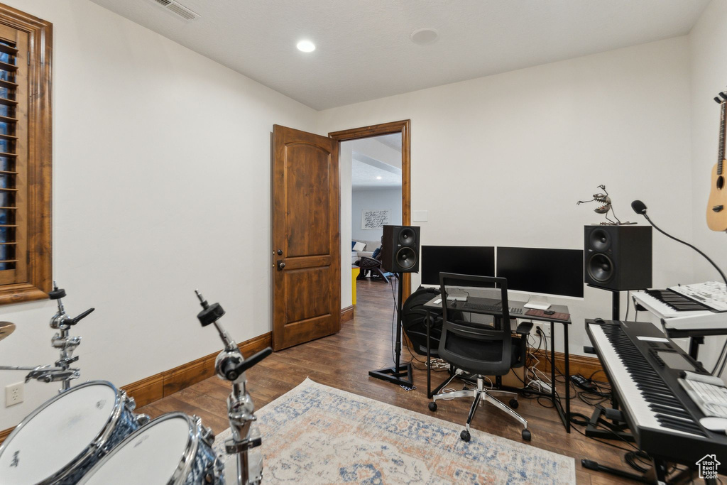 Office space featuring recessed lighting, dark wood-type flooring, and baseboards