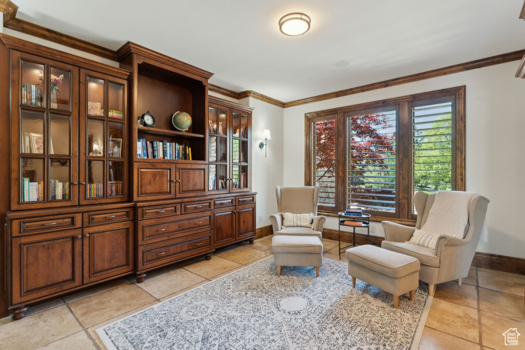 Sitting room with baseboards and crown molding