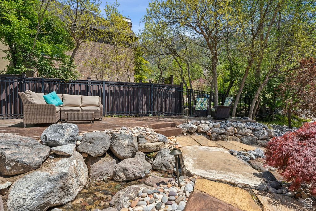 View of yard featuring an outdoor living space and a deck