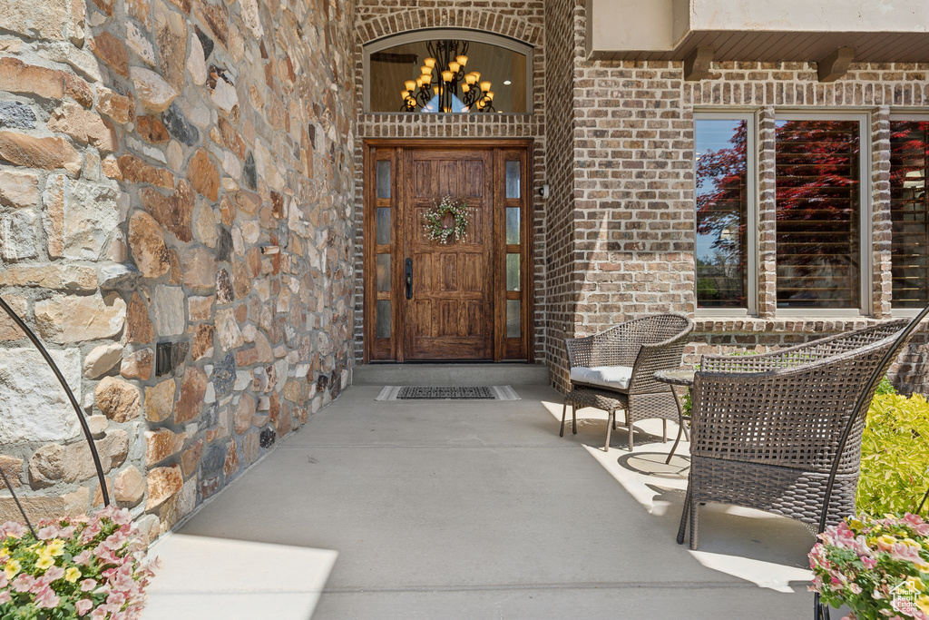 Entrance to property featuring brick siding and stone siding