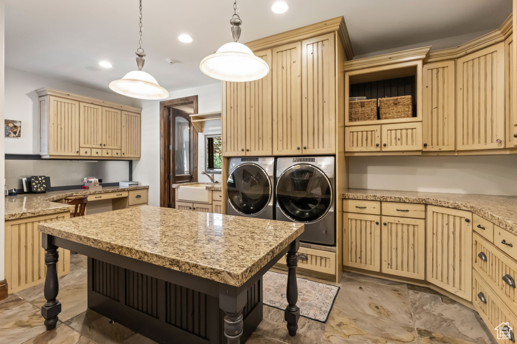 Laundry area with separate washer and dryer, cabinet space, and recessed lighting