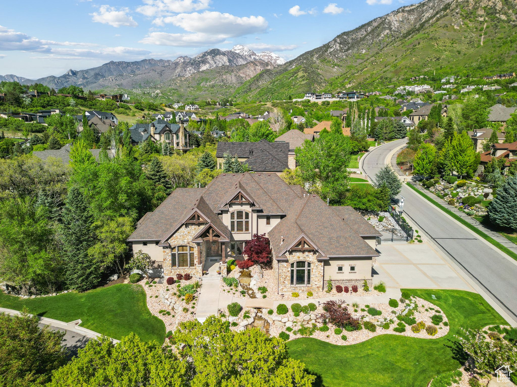 Aerial view of property and surrounding area with a mountainous background