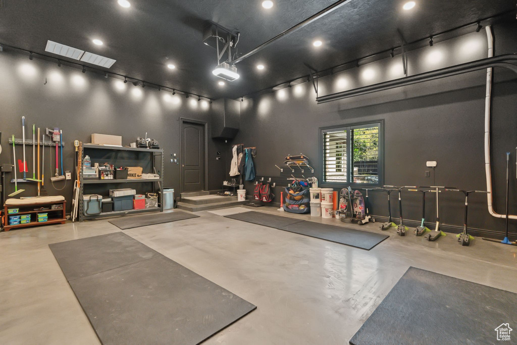 Garage featuring a garage door opener and recessed lighting