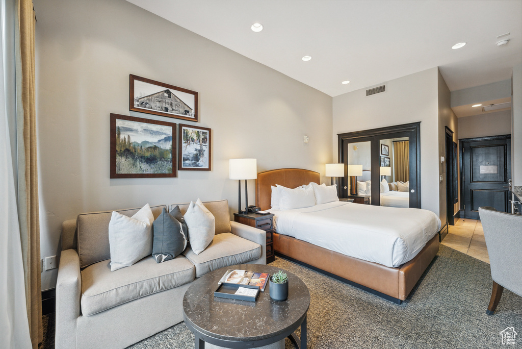 Tiled bedroom featuring recessed lighting