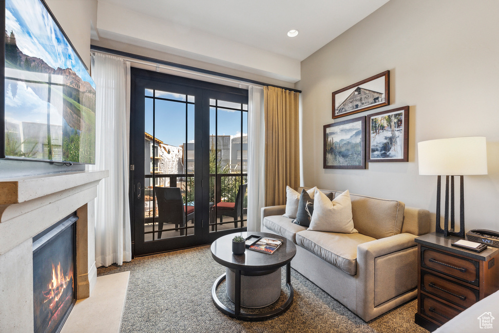 Living area featuring a fireplace, carpet flooring, and recessed lighting