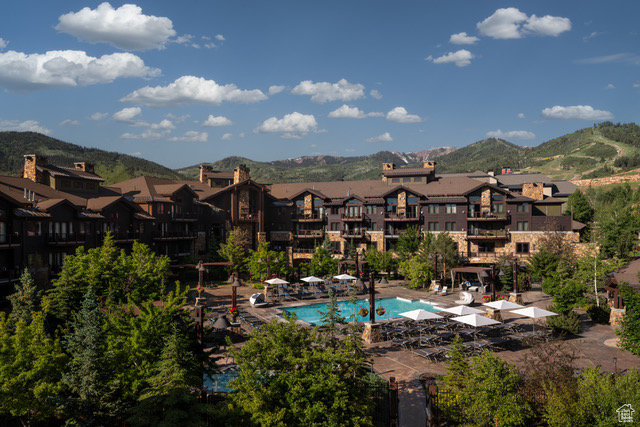 Community pool with a residential view and a mountain view