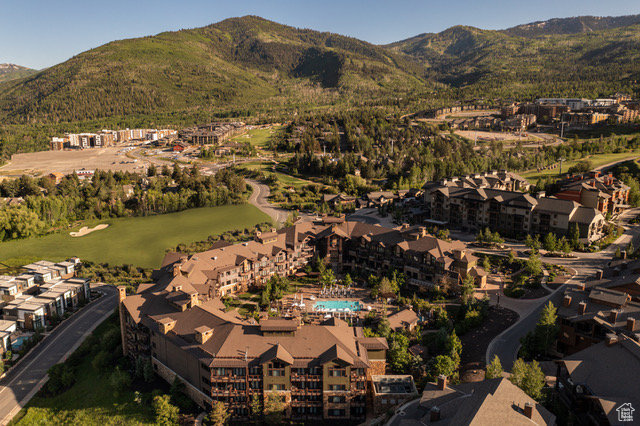 Aerial view of residential area with mountains and a local golf course