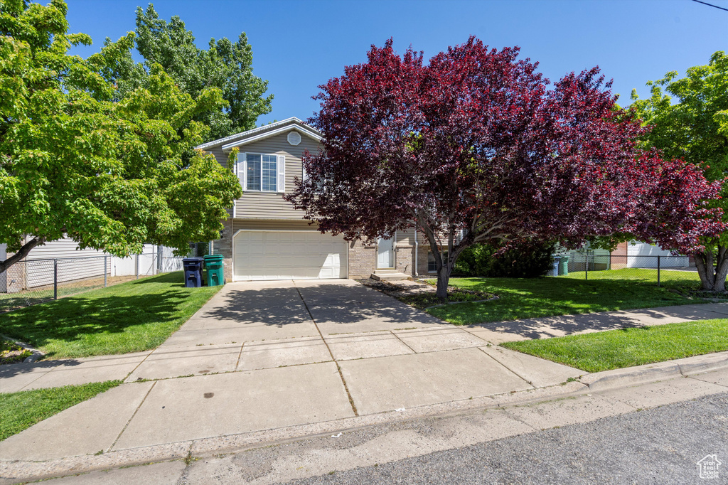 Obstructed view of property with a garage and driveway