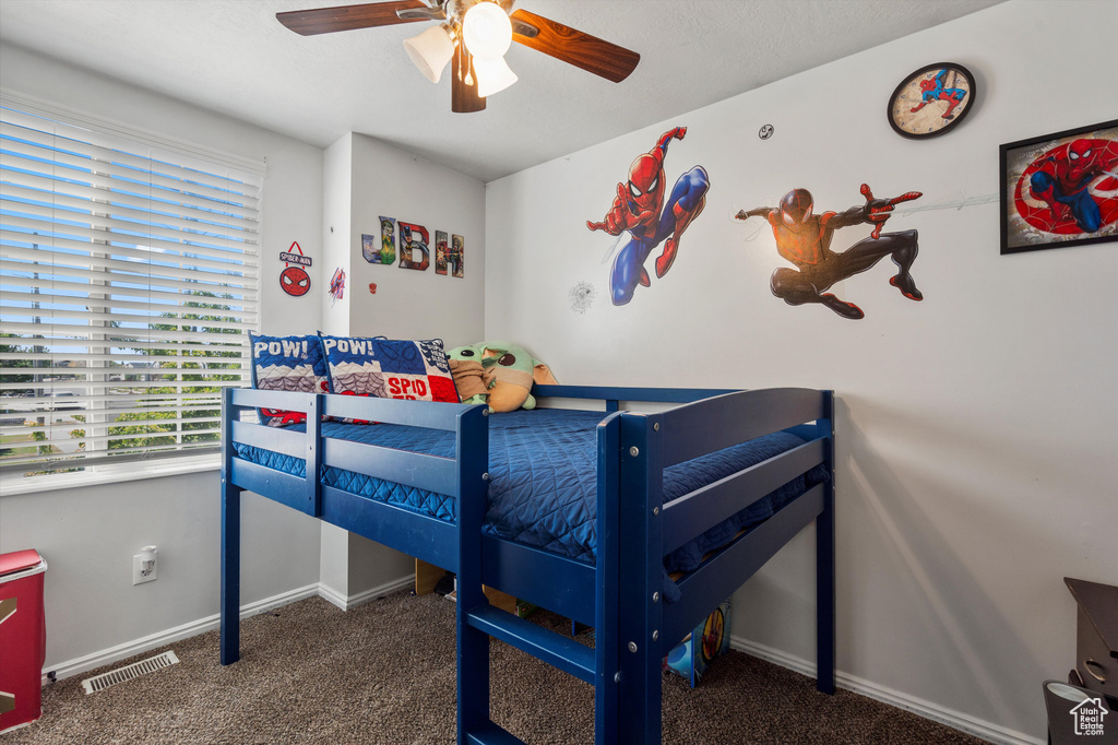 Carpeted bedroom with baseboards and ceiling fan