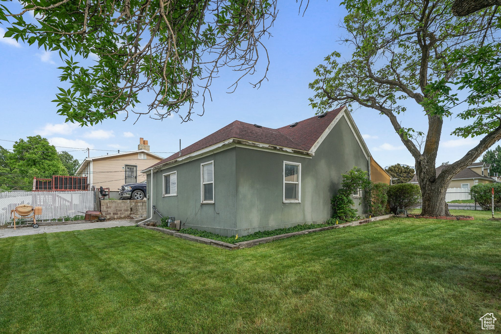 View of property exterior with stucco siding and roof with shingles