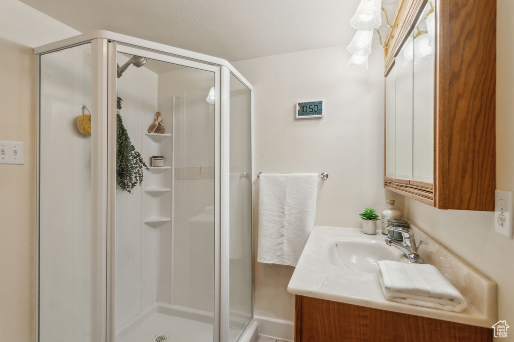 Bathroom with a shower stall and vanity