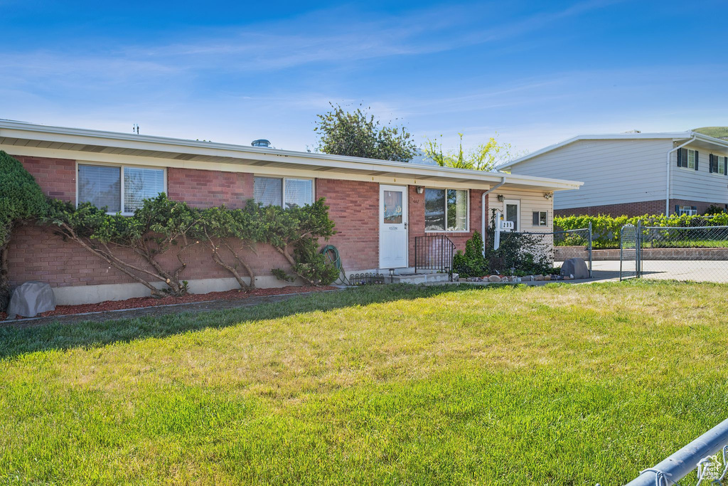 Ranch-style home featuring brick siding
