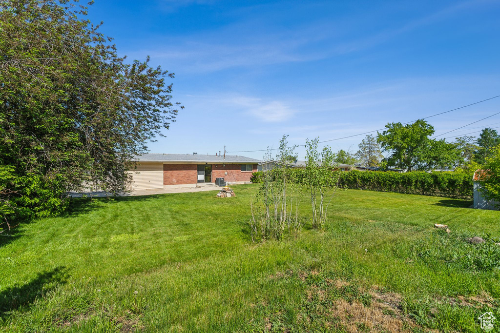 View of green lawn with a patio