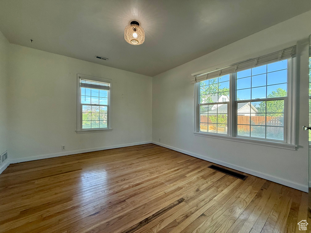 Unfurnished room with hardwood / wood-style flooring and baseboards
