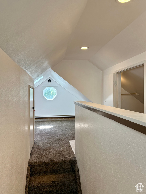 Stairs featuring carpet floors, vaulted ceiling, recessed lighting, and a baseboard heating unit