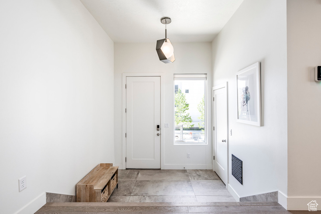 Foyer entrance featuring baseboards and wood finished floors