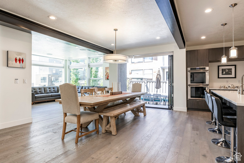 Dining area with baseboards, light wood-type flooring, and recessed lighting