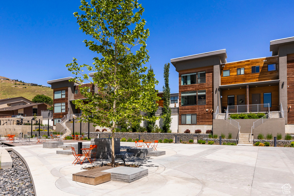 View of community with stairs and a patio