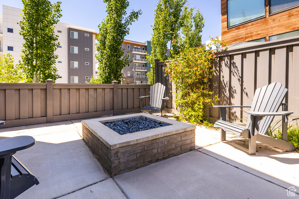View of patio with a fire pit