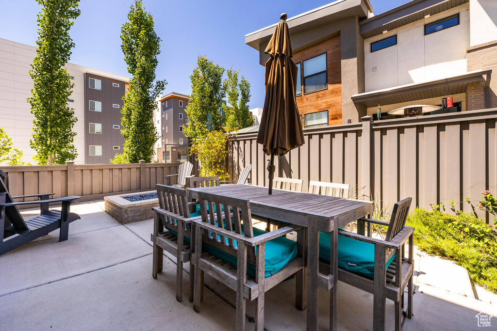 View of patio featuring a fire pit and outdoor dining area