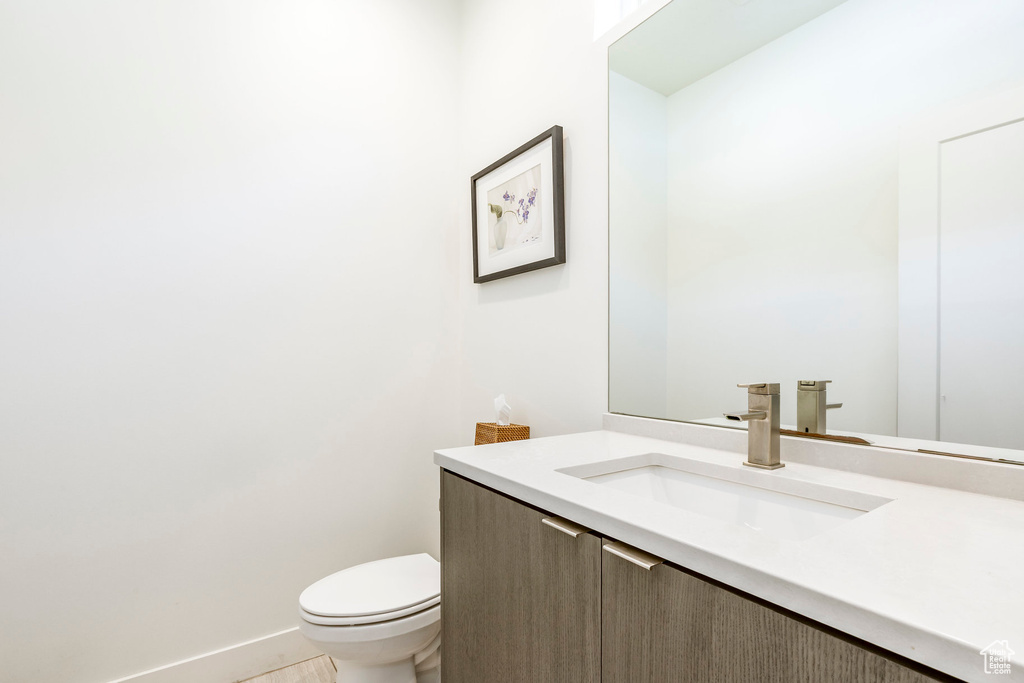 Half bath with vanity and toilet