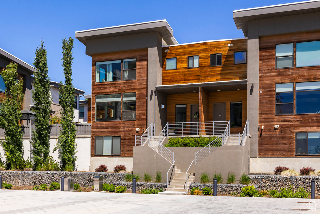 Modern home featuring stairway and covered porch