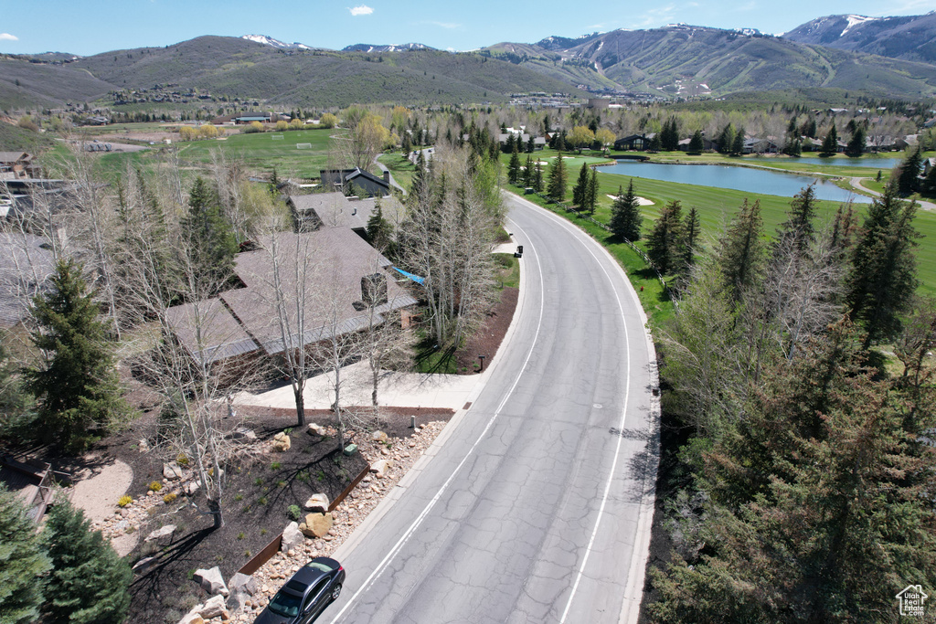 Aerial view of property and surrounding area featuring a water and mountain view