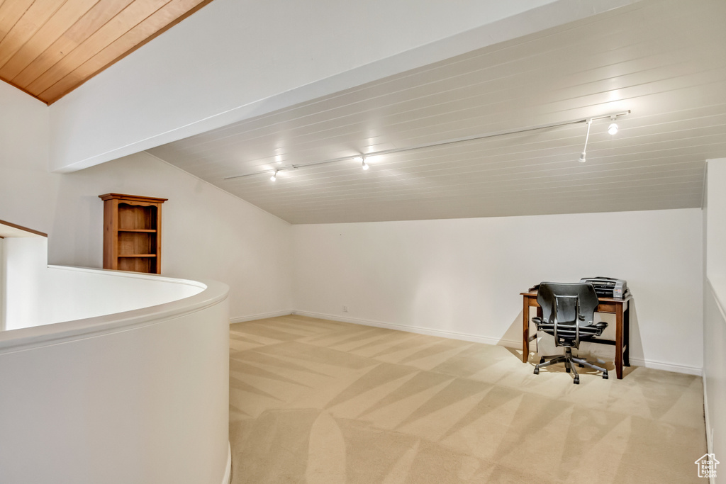 Additional living space featuring lofted ceiling, light carpet, wooden ceiling, baseboards, and a desk