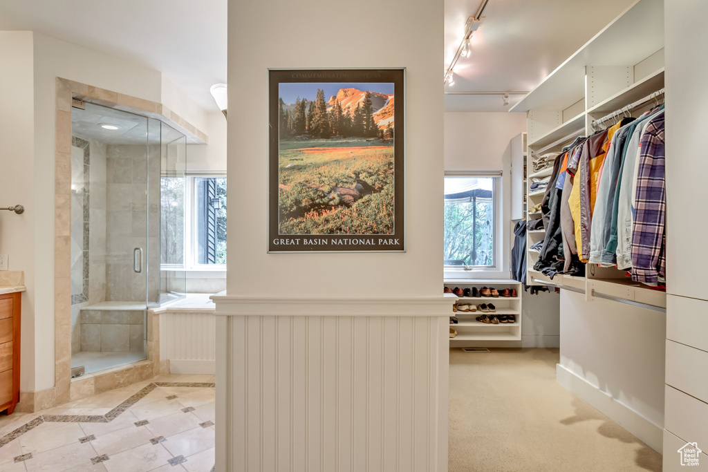 Walk in closet with tile patterned flooring