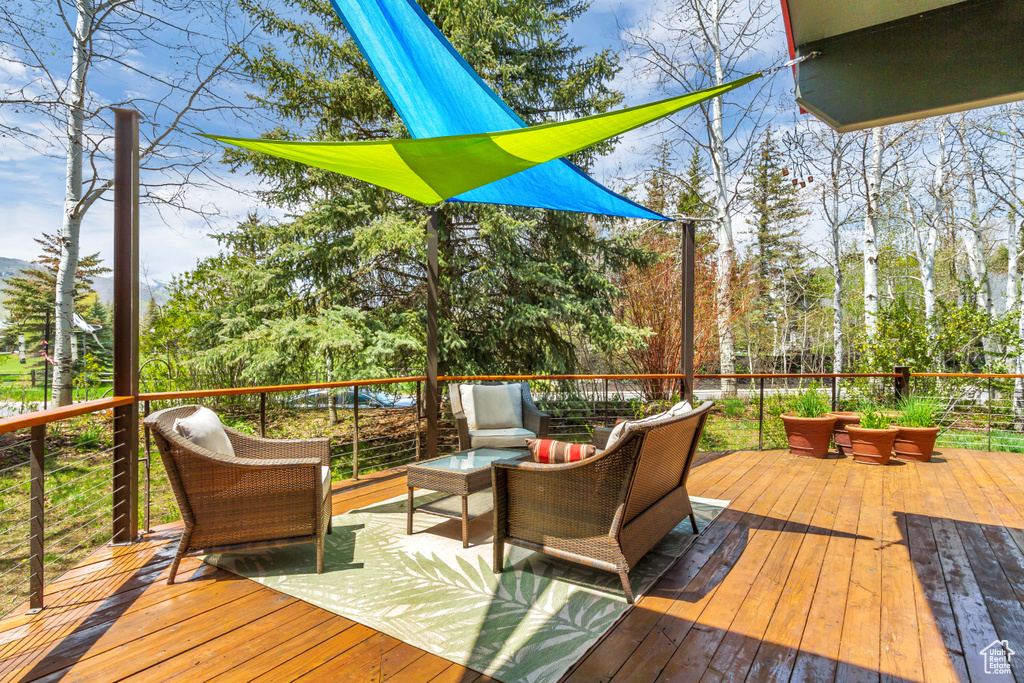 Wooden deck featuring an outdoor hangout area