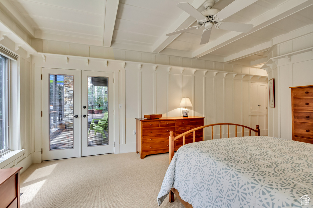 Bedroom featuring access to outside, carpet floors, french doors, beamed ceiling, and a ceiling fan