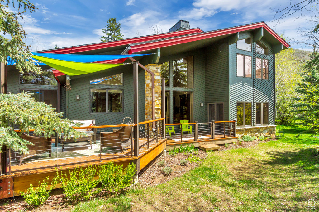 Rear view of house featuring a deck