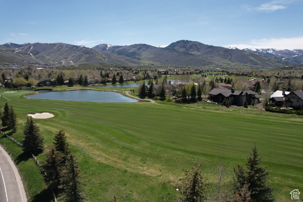 Mountain view featuring a nearby body of water and a local golf course