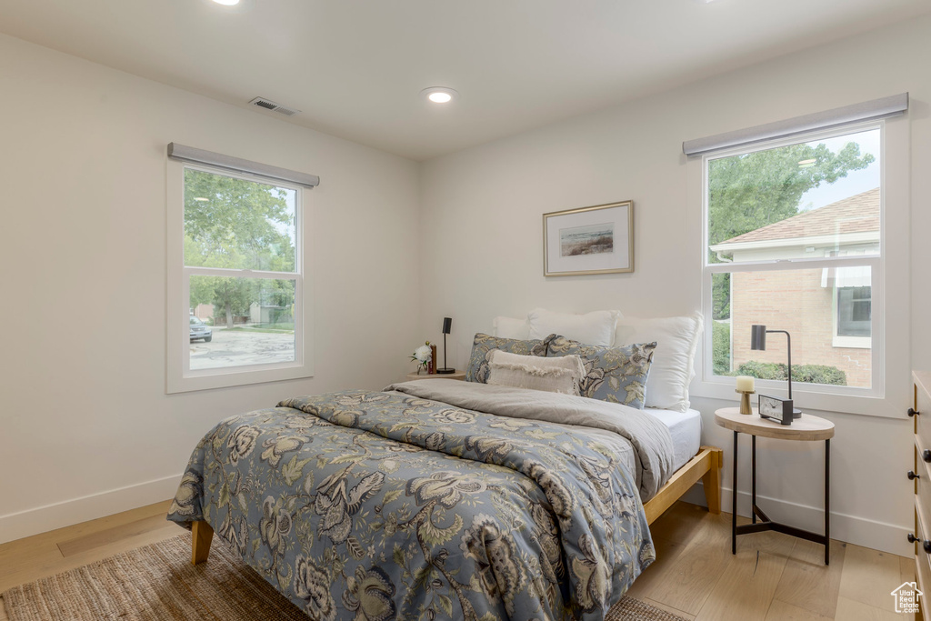 Bedroom featuring light wood-style flooring, baseboards, and recessed lighting