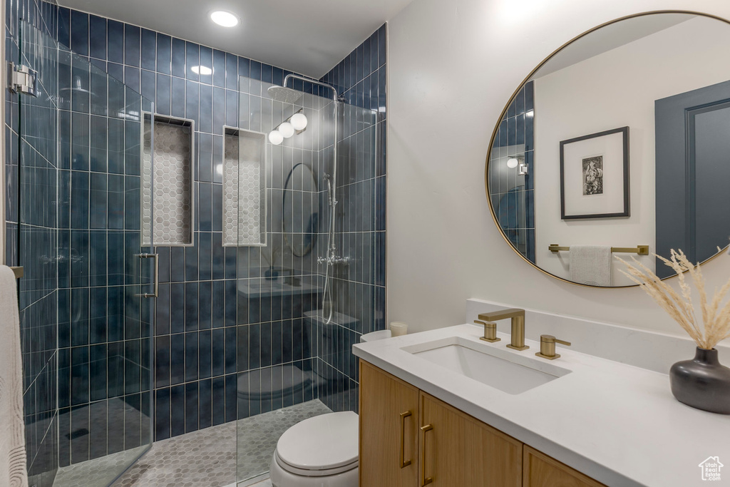 Full bath with vanity, toilet, a stall shower, and recessed lighting
