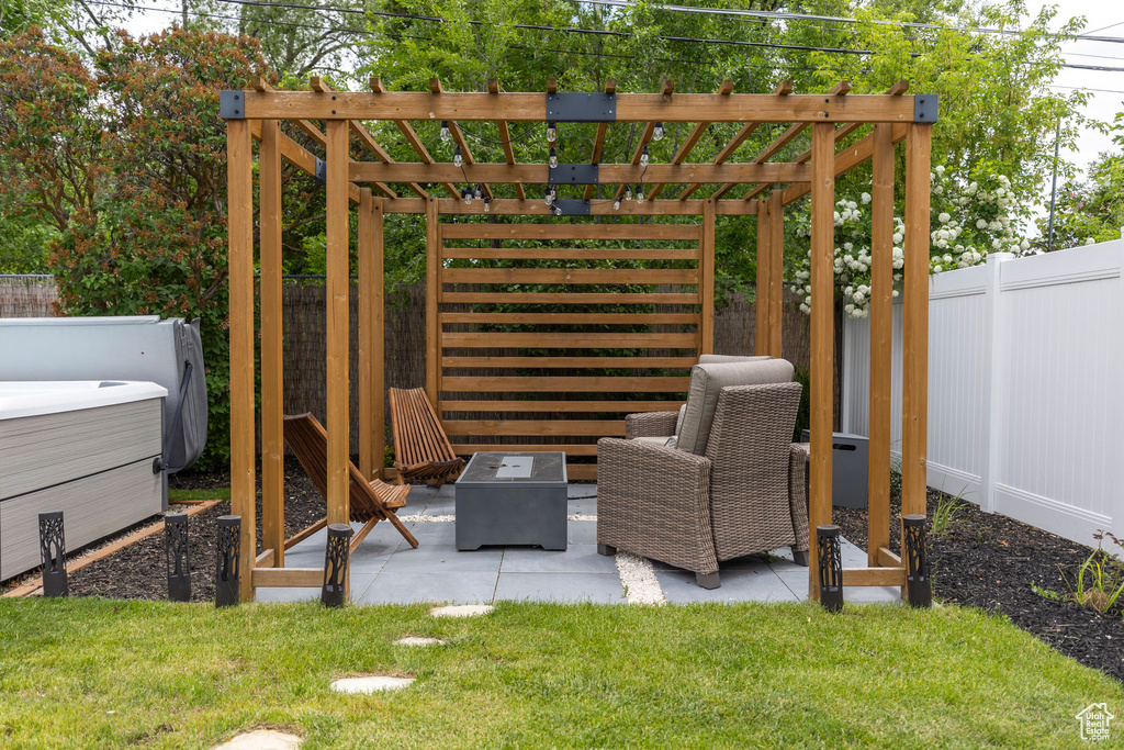 View of patio with an outdoor fire pit