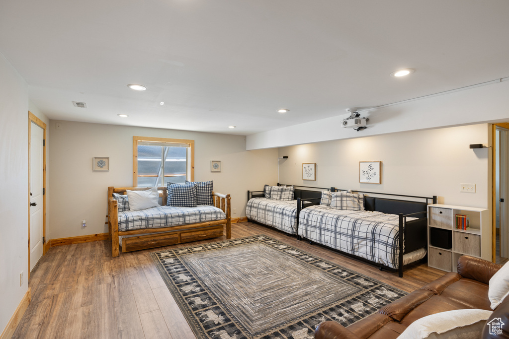 Bedroom featuring wood finished floors, baseboards, and recessed lighting