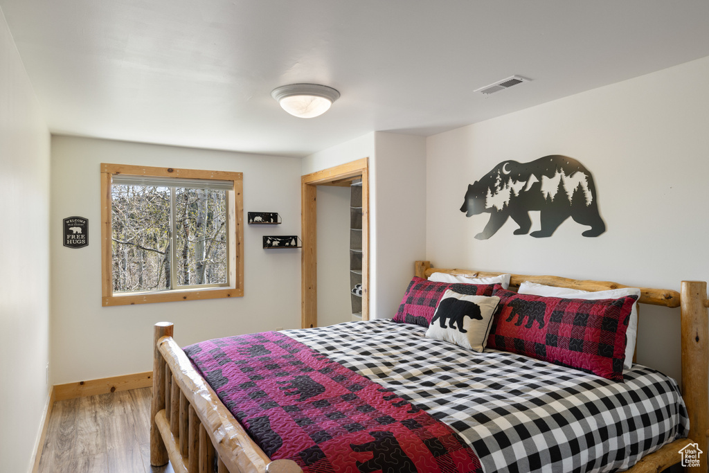 Bedroom featuring wood finished floors and baseboards