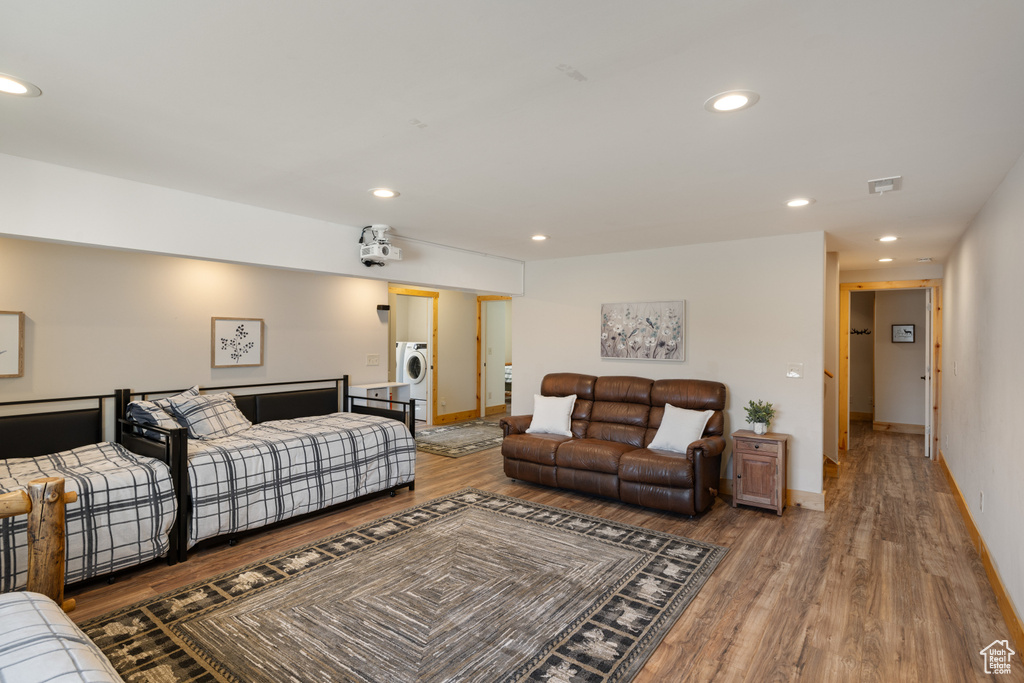 Living area with wood finished floors, washer / clothes dryer, recessed lighting, and baseboards