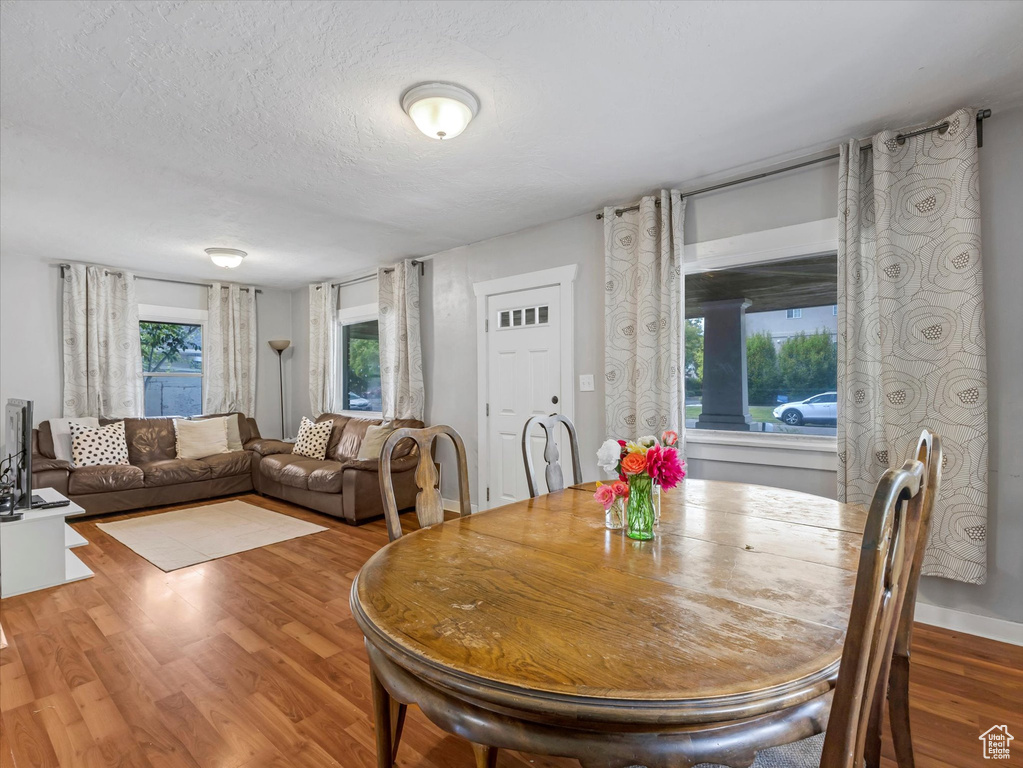 Dining room with wood finished floors and a textured ceiling