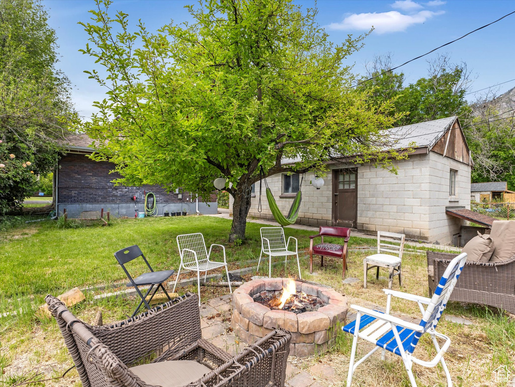 View of patio with an outdoor fire pit