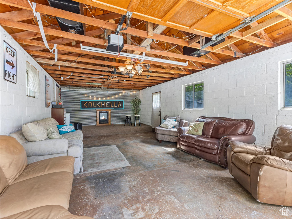 Living room featuring concrete flooring and concrete block wall