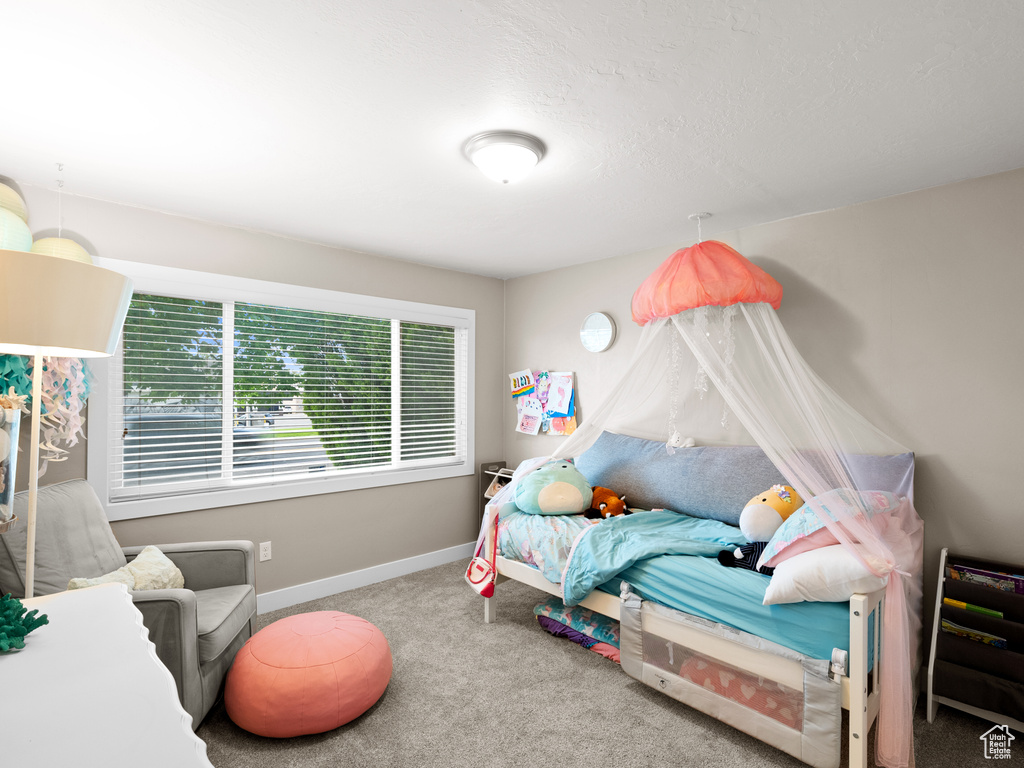 Bedroom featuring carpet floors and baseboards