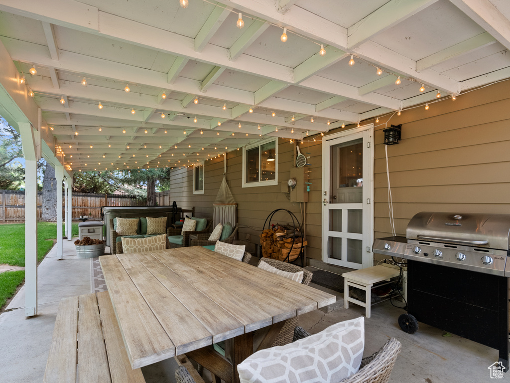 Fenced backyard with a patio area, grilling area, and outdoor dining area