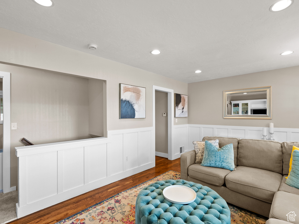 Living area featuring wood finished floors, wainscoting, and recessed lighting