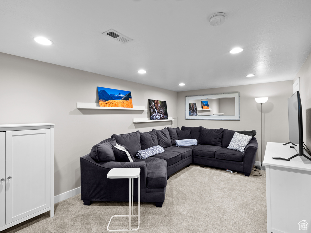 Carpeted living room featuring recessed lighting and baseboards