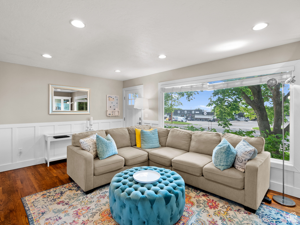 Living room with wainscoting, wood finished floors, and recessed lighting