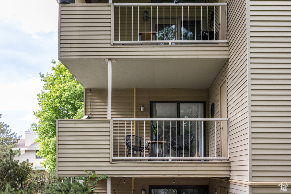 View of exterior entry featuring a balcony
