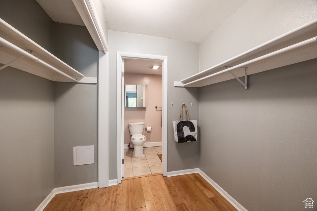 Walk in closet featuring light wood-type flooring