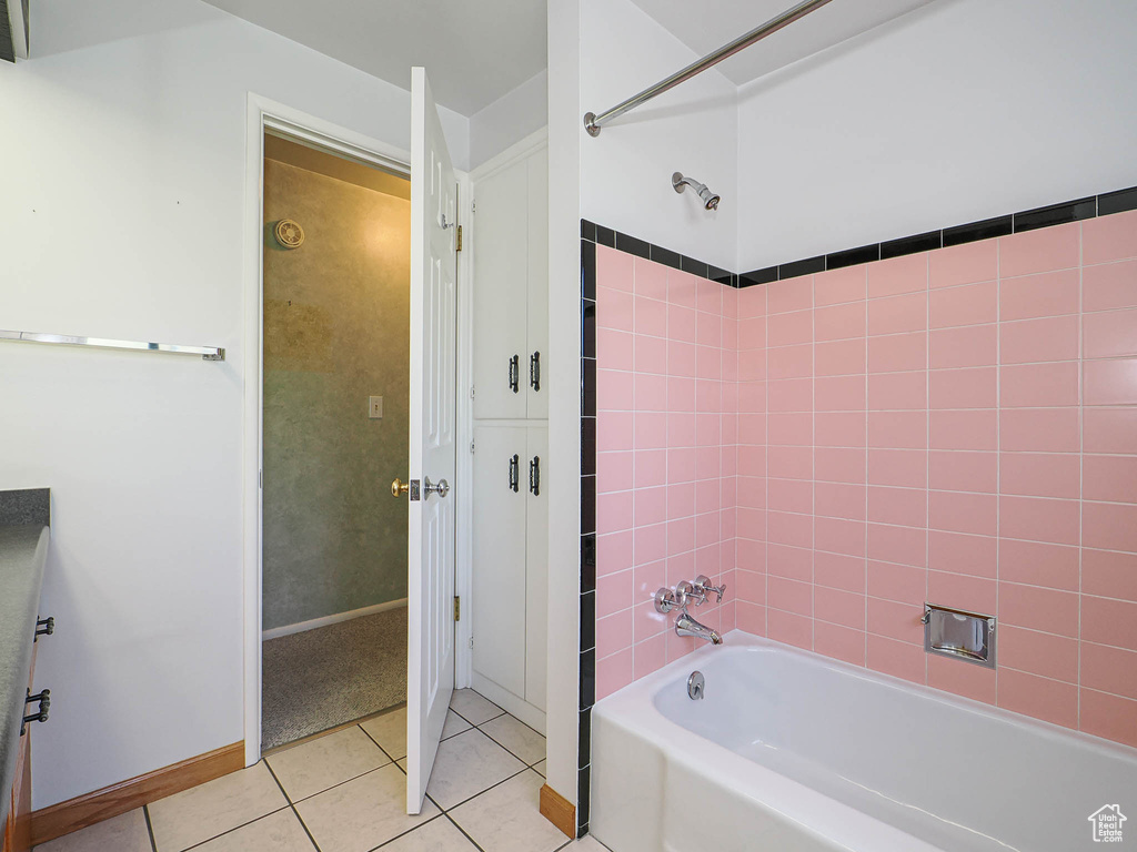 Full bathroom featuring tile patterned flooring, shower / tub combination, and baseboards